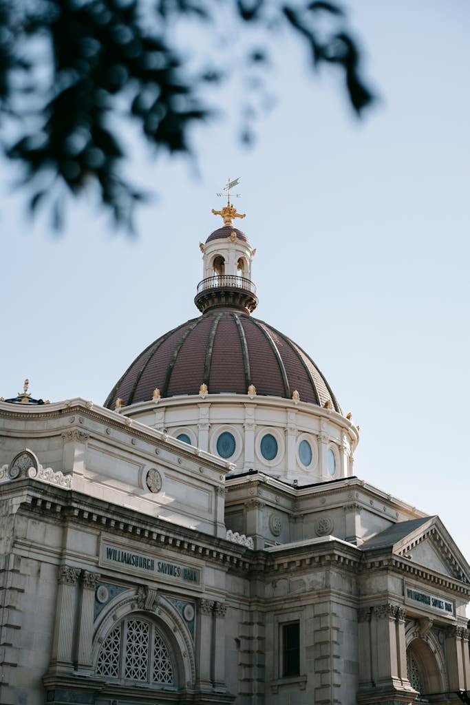 From below of aged stone building with ornamental decor and dome in United States in soft daylight